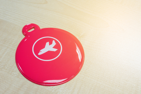 Circle pink luggage tag on wooden tableの写真素材