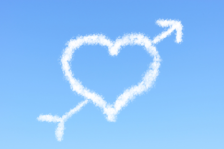 Valentine concept heart shaped cloud and arrow with clear blue skyの写真素材