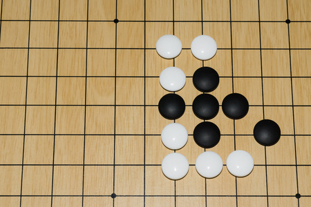 Desk for traditional asian strategy board game Go and black and white bones, Top viewの写真素材