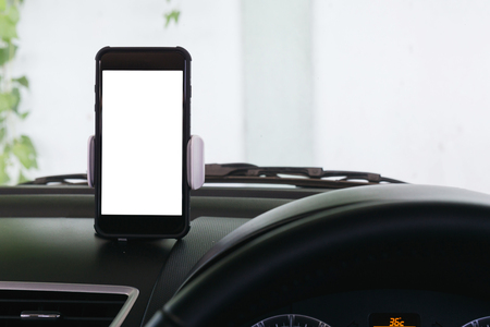 Phone with white screen holding in carの写真素材