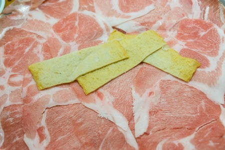 The tofu on the top of raw meat and pork slide in restaurant.の写真素材