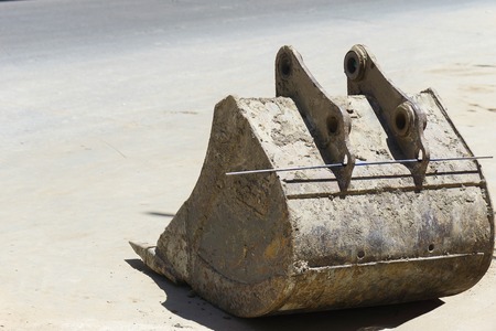 The excavator wiht dust and rust put on the concrete floor.の写真素材