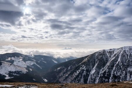 Snow covered mountains with clouds and mist in valley, Low Tatras Dumbier, Slovakia
