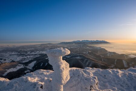 Winter landscape in mountains illuminated at sunrise and in background High Tatras, Slovakia Velky Chocの写真素材