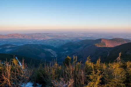 view from Lys mountains to the valley and the surrounding towns below it early in the morning, czech beskydyの写真素材