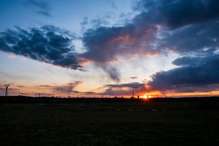 sunset with a beautiful sky on a golf course and a coal mine in the background , karvinaの写真素材