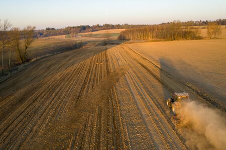 aerial shots of the tractor at sunrise while working in the field, czechの写真素材