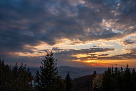 sunrise in the mountains with forest in the foreground with beautiful sky, czech republic beskydy Javorovy vrchの写真素材