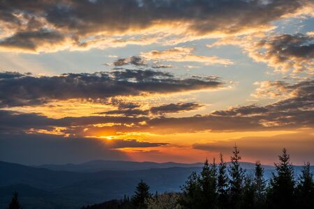 sunrise in the mountains with forest in the foreground with beautiful sky, czech republic beskydy Javorovy vrchの写真素材