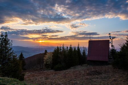 cottage on top of the mountain at sunrise in Beskydy Javorovy vrch, czech 13.4.2020の写真素材
