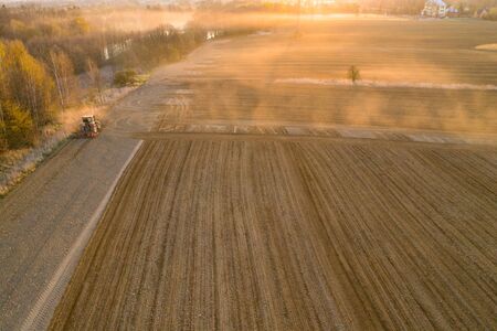 aerial shots of the tractor at sunrise while working in the field, czechの写真素材