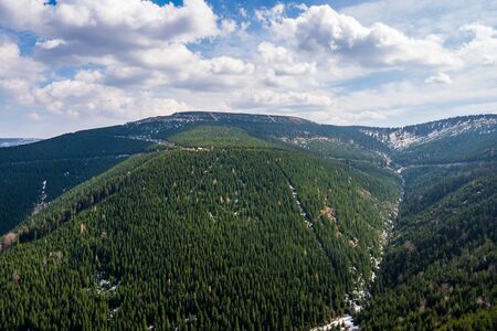 beautiful view of the mountains covered with spruce trees with a beautiful sky in Jeseniky mountains, czech Dlouhe Strane 18.4.2020の写真素材