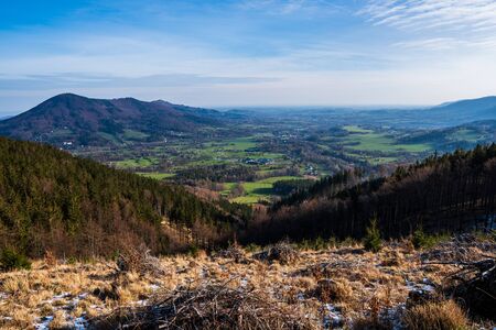 view to the valley in the mountains with a beautiful village and field in the spring, Czech Beskydy Celadnaの写真素材