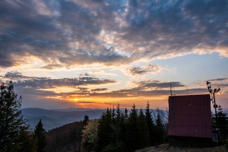 cottage on top of the mountain at sunrise in Beskydy Javorovy vrch, czech 13.4.2020の写真素材