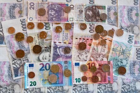 coins and banknote, euro and crown side by side, CZK EURO EURの写真素材