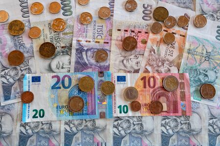 coins and banknote, euro and crown side by side, CZK EURO EURの写真素材