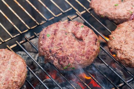 BBQ Grilled Burgers Patties On The Hot Flaming Charcoal Grill, Top View. Cookout Food, Good Snack For Outdoor Party Or Picnicの写真素材