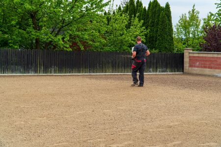 planting a new lawn in the garden, a man sows grass in the garden, a new lawnの写真素材