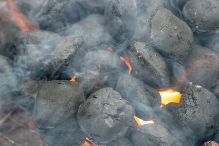 BBQ Grill Pit With Glowing And Flaming Hot Charcoal Briquettes, Food Background Or Texture, Close-Up.の写真素材