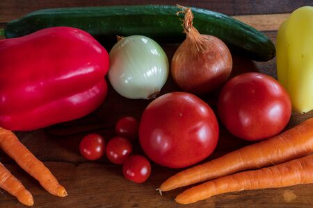 Beautiful background healthy organic eating. Studio photography the frame of different vegetables and mushrooms on the old brown boards with free spaceの写真素材
