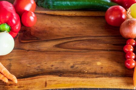 Mixed vegetables on wooden table top view. Organic food from farm.の写真素材