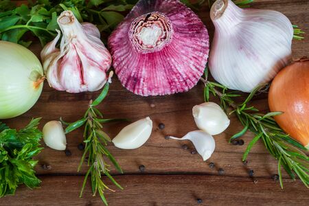 Garlic and onion on the old wooden tableの写真素材