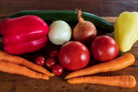 Beautiful background healthy organic eating. Studio photography the frame of different vegetables and mushrooms on the old brown boards with free spaceの写真素材
