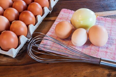 fresh brown and white chicken eggs on a plate on wooden backgroundの写真素材