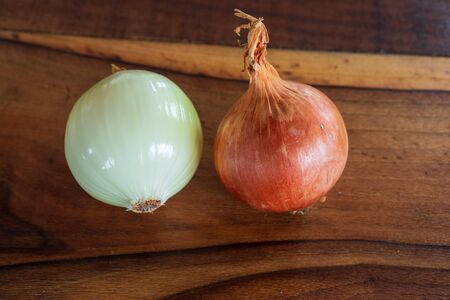 Onion on a old wooden table close upの写真素材