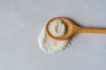 sea salt on wooden spoon isolated on white backgroundの写真素材