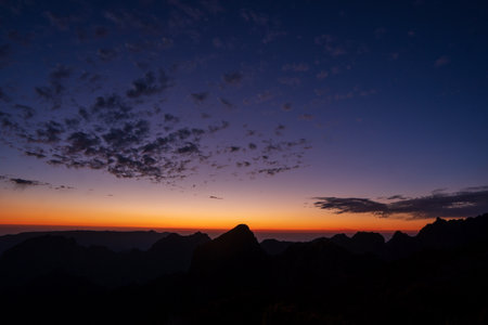 Sunrise in Madeira mountains peaks in sunlight, scenic view over landscape and Pico Ruivo, Portugal.の写真素材