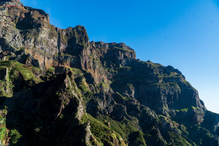 Beautiful hiking trail from Pico do Arieiro to Pico Ruivo, Madeira island. Footpath PR1 - Vereda do Areeiro. On sunny summer day above the clouds. Portugal.の写真素材