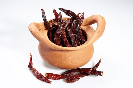 Chilli red dried pepper isolated in thai style pot and white backgroundの写真素材