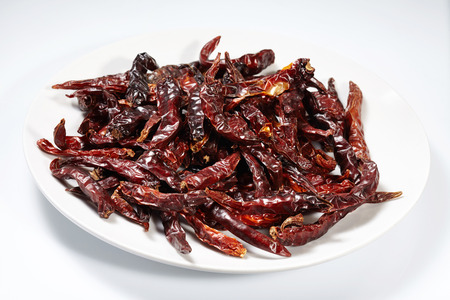 Chilli red dried pepper isolated on white plate and white backgroundの写真素材