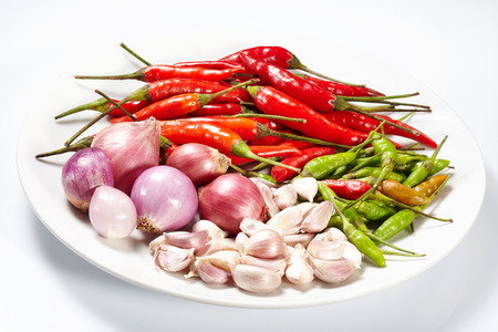 Garlic and onion and Chilli red dried pepper isolated on white plate and white backgroundの写真素材