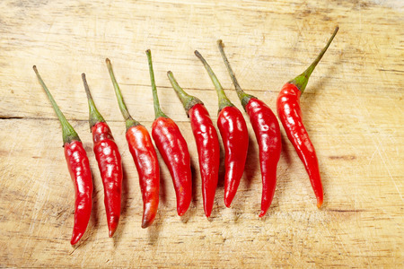 Red chilli peppers on wooden surfaceの写真素材