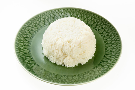 Rice on green plate isolated on white backgroundの写真素材