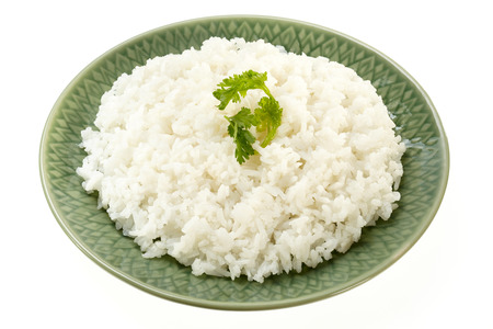 Rice on green plate isolated on white backgroundの写真素材