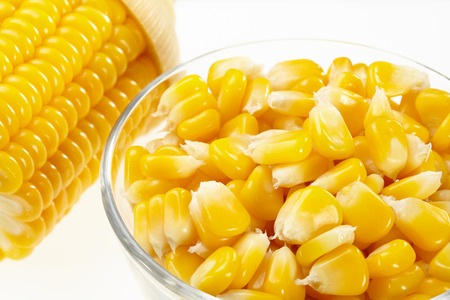 Corn in a small glass bowl isolated on white backgroundの写真素材