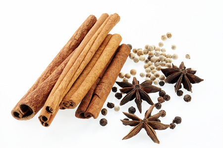 Cinnamon, poikak, black and white peppercorn. Isolated on white background.の写真素材