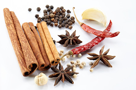 Cinnamon, poikak, chilli, garlic, black and white peppercorn. Isolated on white background.の写真素材