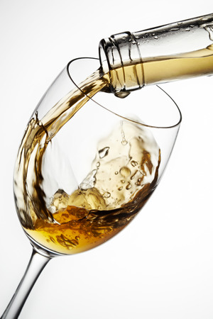 Glass of wine with splash, isolated on white backgroundの写真素材