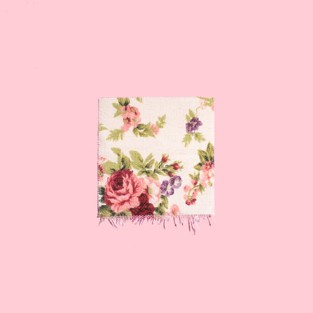 Embroidery floral pattern on fabric background. Handmade. Spring inspired layout.