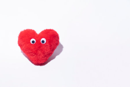Valentine's day minimal creative layout, furry red heart with eyes, romantic greeting card.の写真素材