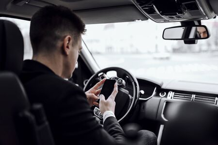 Handsome guy driving automobile in the city