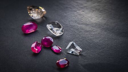 Collection of Red ruby and topaz, Precious stones for jewellery on black matte paper background, rough paperの写真素材