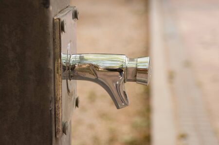 Close-up of contemporary tap of a street fountain in a parkの写真素材