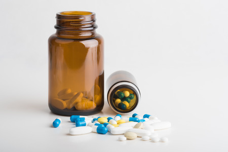 Medicines, supplements and drugs in a bottle on a white background