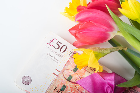 Stack of pounds associated with a pink ribbon