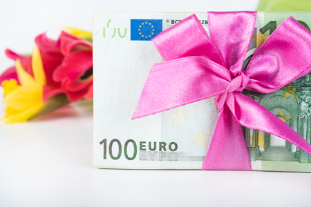 Stack of euro associated with a pink ribbonの写真素材
